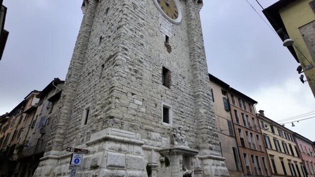 Low angle tilt up of Torre della Pallata clock tower, Brescia, Italy