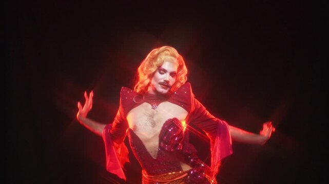 Flamboyant drag queen dancing and performing on stage