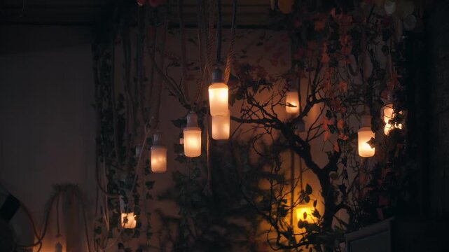 Warm lights hang from dark vines. Flickering bulbs glow softly in dimness. Branches twist around the shadows. Ambient glow adds cozy, mysterious atmosphere. Ideal for intimate, rustic