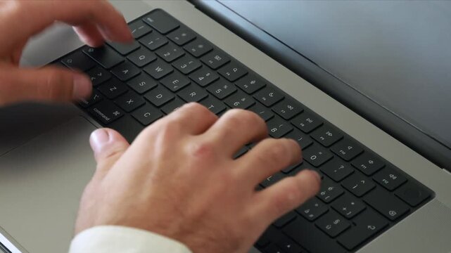 Worker hands typing on laptop keyboard alternative focus shift concept tech environment close up