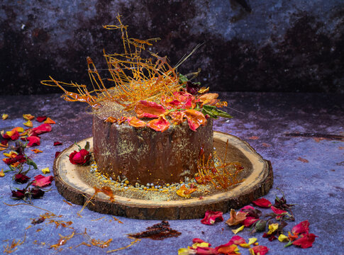 Chocolate layer cake covered in crystalized rose petals