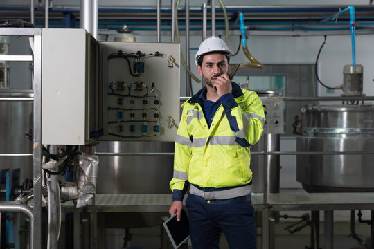 Professional male electrician inspect and maintenance electrical system in industrial facility