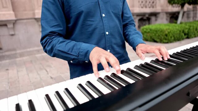 Street pianist playing music on an electric keyboard