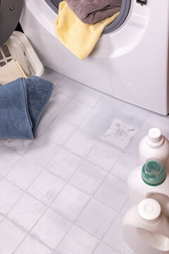 Doing laundry with towels, washing machine, and detergents