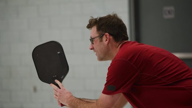 Co ed pickleball players in a modern gymnasium