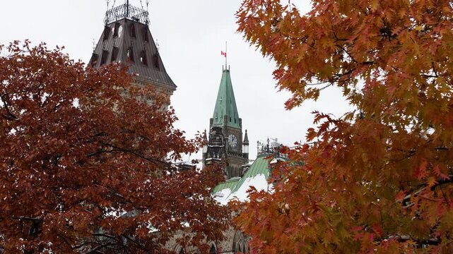 Parliament of Canada with Canadian flag and autumn trees in Ottawa downtown