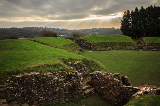 Caerleon Roman Amphitheatre grassy mounds and stone ruin remnants under sun