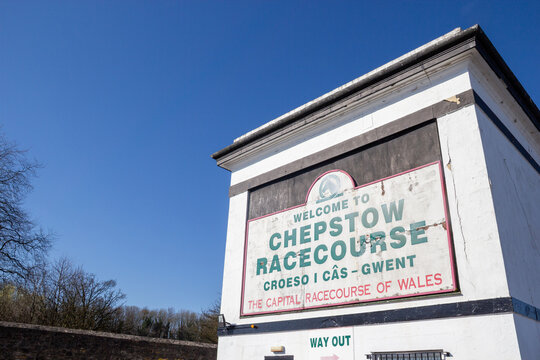 Entrance gate sign welcoming visitors to Chepstow Racecourse under blue sky