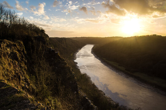 Sunset glowing over Wintour's Leap winding river landscape in the Wye Valley