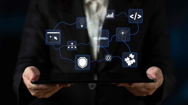 Business Professional Holding Tablet with Digital Icons Representing Technology, Data, and Software Development in Modern Workspace Quark.