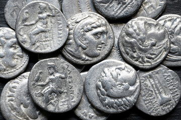 Close-up of a pile of ancient Greek coins. Macro photography of old silver money of Alexander the Great. Historical currency, wealth and archaeology concept © scaliger