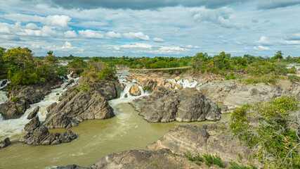 Khone Phapheng Waterfall, the largest waterfall on the Mekong River, features powerful multi-tiered cascades rushing over massive rock formations, creating one of the most dramatic natural © Narong Niemhom