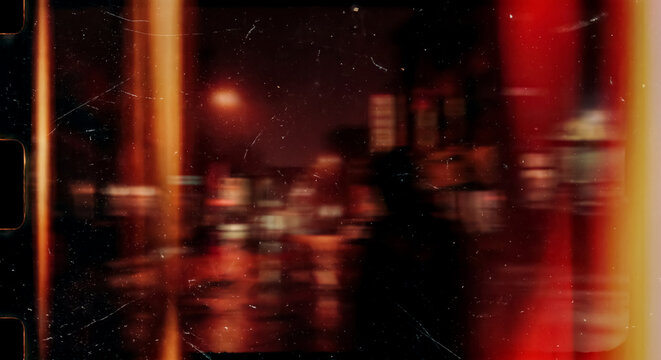 Vintage red tinted film shot of neon-lit city street with blurred