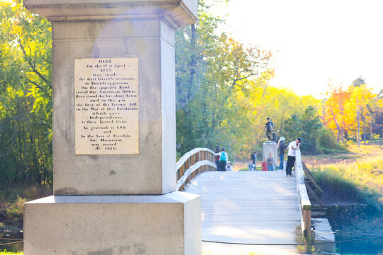 The Historic Battle Monument, Old North Bridge, and Minute Man Statue Framed by Autumn Foliage in Concord, Massachusetts