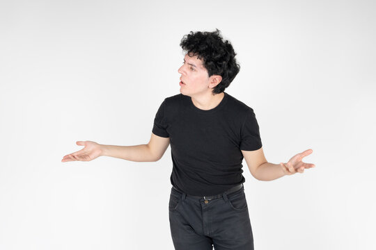 Studio shot of man expressing doubt and confusion with open arms gesture