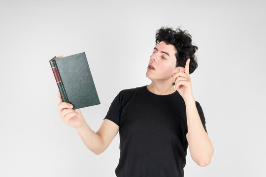 Studio shot of young man acting or reading literature