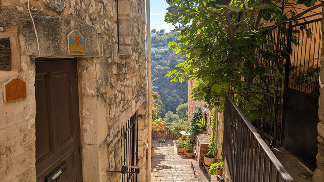 Narrow cobblestone alley in a medieval French village in Tourrettes-sur-Loup, France. 