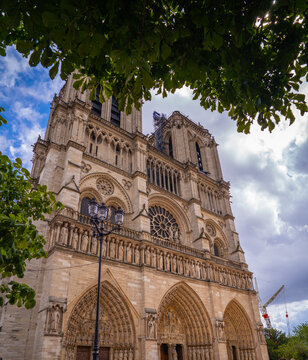 The Notre-Dame Cathedral stands tall on the &Icirc;le de la Cit&eacute;, its twin towers rising above the Seine. The Gothic fa&ccedil;ade is lined with sculpted figures and ornate arches. 
