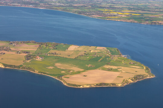 Aerial view of the island of Ven, featuring agricultural fields, coastal cliffs, and surrounding blue waters in Sankt Ibb, Skane County, Sweden.