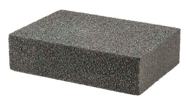 Close-up of dark gray rectangular cleaning sponge isolated on white background