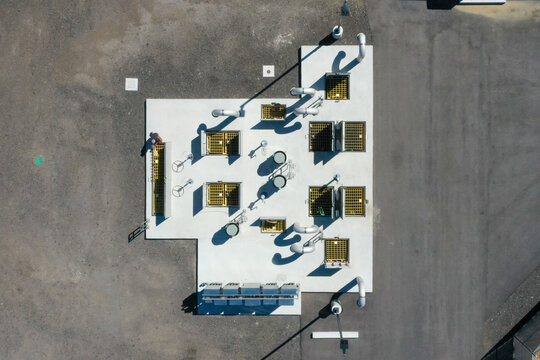 Aerial view of a water treatment facility with concrete pads, yellow metal grates, and industrial piping in Colorado, United States.
