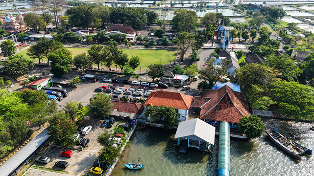 Aerial view of Jepara Kartini Ferry Terminal with its terminal building, jetty, parking area, and coastal waters in Jepara, Central Java, Indonesia.