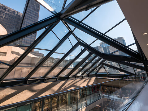 A triangular skylight roof over a mall concourse, made of glass with laminated graphite steel trusses