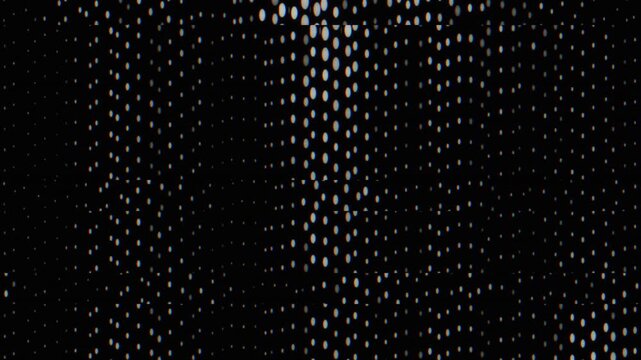 Glowing dot pattern shifts across a black abstract field with subtle digital distortion