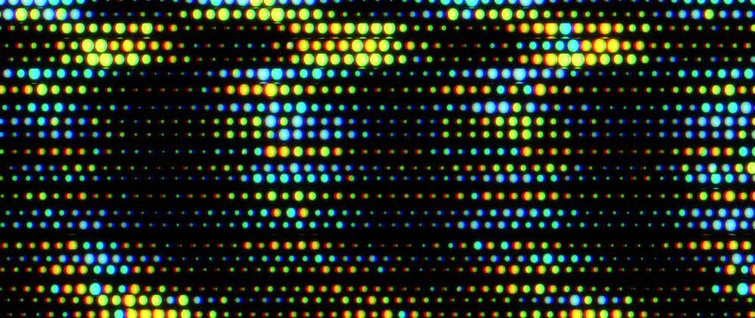 Colorful LED light grid pulses and shifts in rows against a black background