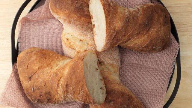 Freshly baked artisan bread rotating in a basket