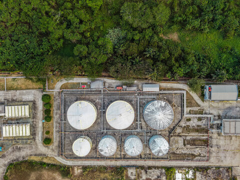 Aerial view of Pro Tank Terminal - International Fuel Storage with large industrial fuel tanks, pipelines, and surrounding lush tropical vegetation in Samarinda, East Kalimantan, Indonesia.