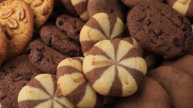 Assortment of delicious chocolate and butter cookies rotating