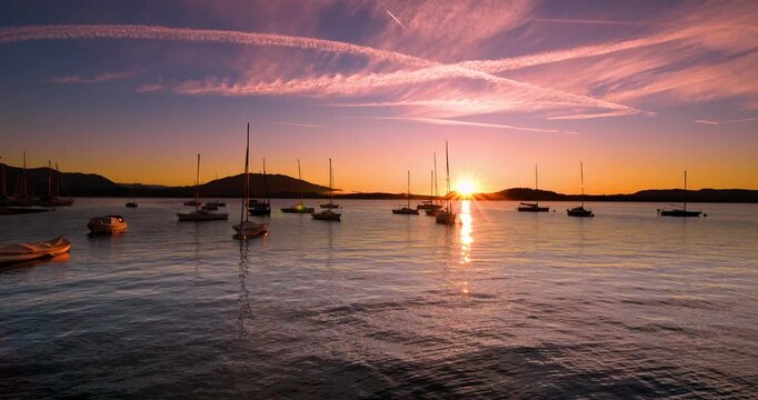  Spectacular pink sunrise over the port of Lesa Italy.