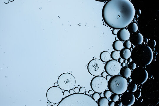 Oil droplets on water, blue background