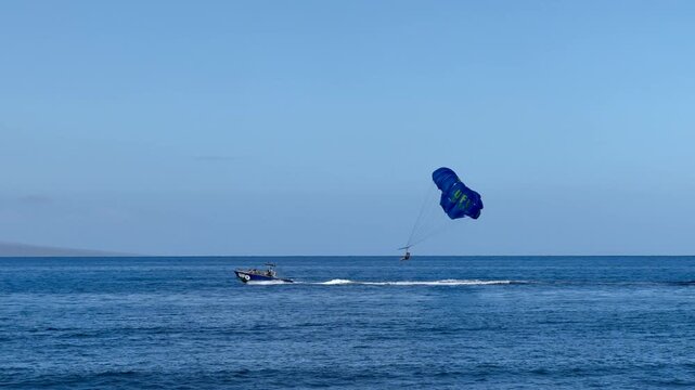 Parasailing on Maui, Hawaii, with Lanai island visible in the background