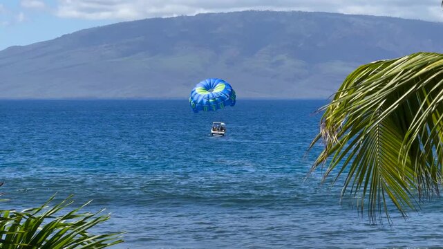 Parasailing on Maui, Hawaii, with Lanai island visible in the background