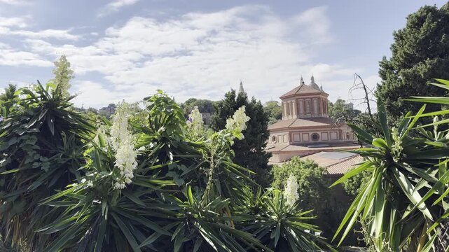 Barcelona, Spain, October 13, 2026 - View of the Archaeology Museum of Catalonia (MAC) through dense yucca plants on Montjuic hill.