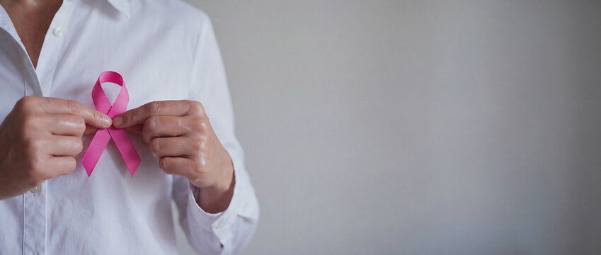 Dedicated Person Holding Pink Ribbon for Breast Cancer Awareness Campaign Signaling Solidarity and Health Support