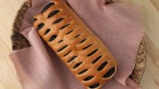 Freshly baked poppy seed roll rotating
