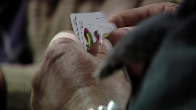 Close Up of Man Hands Holding Playing Cards During Truco Game - 4K