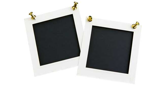 Isolated two blank instant photo frames with golden thumbtacks for displaying memories