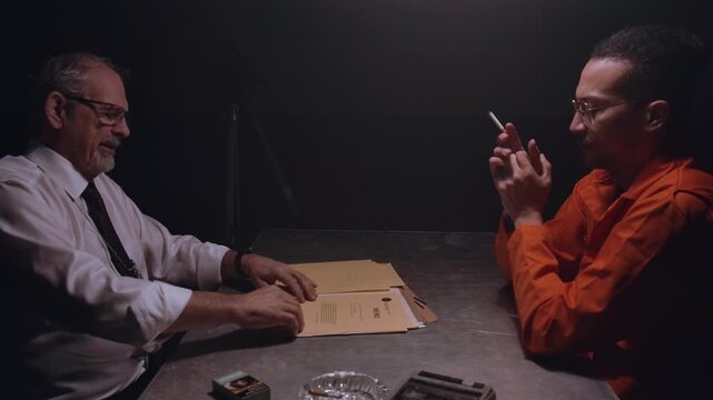 Police officer interrogating a man with documents