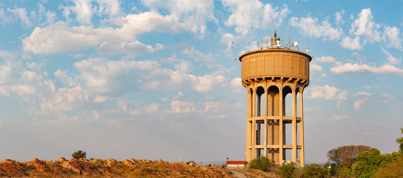 Cloudy sky on Northcliff past the reservoir - Wide watertower landscape
