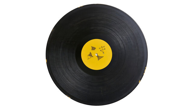 Isolated vintage phonograph record disc with yellow label on plain surface, audio media