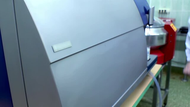 Laboratory analyzer quality control. Technician lab coat loading test sample.