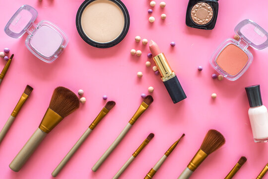 Decorative cosmetic set for natural makeup on pink background top view