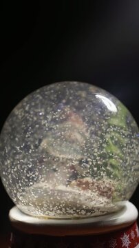 Winter Holiday Snow Globe Macro Shot on Dark Background Video Footage