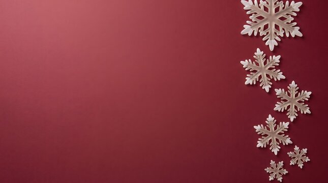 Elegant christmas background with silver snowflakes arranged vertically on a deep red gradient backdrop for holiday season designs