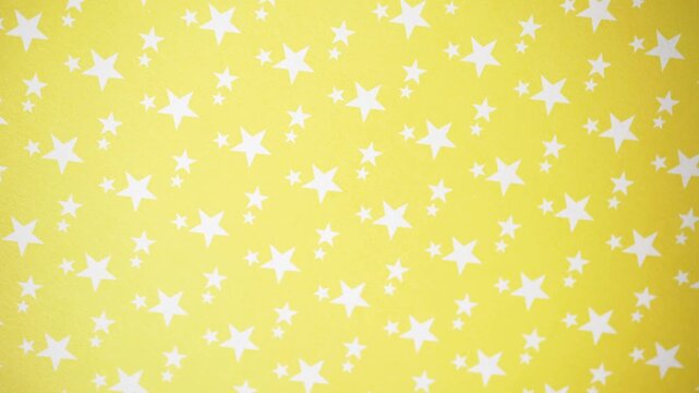 Rotating White Stars on Yellow Background Motion Video Footage