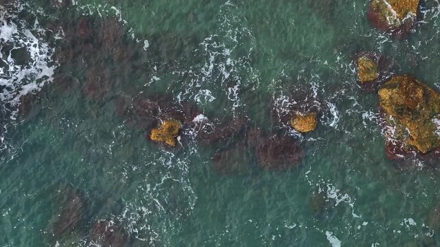 Aerial view of the rocky coastline and turquoise sea of Costa dei Trabocchi in Marina di San Vito, Abruzzo, Italy.